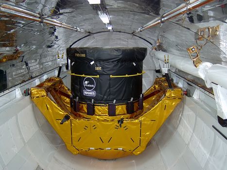 A photograph of the robotic arm inside the cargo bay of a 
NASA Space Shuttle.