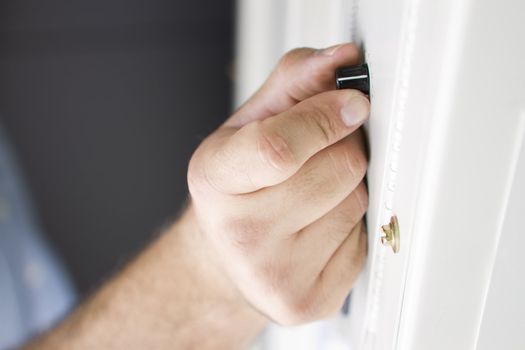 Clean close up right hand holding a dial knob and tuning.