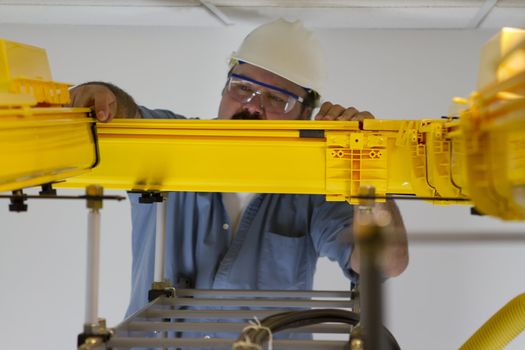 Telecommunication worker inspecting fiberoptic cables in the fiberduct