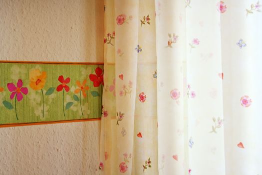 orange wallpaper with trim and yellow curtain