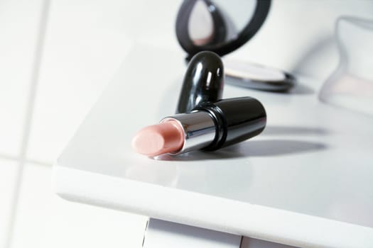 black lipstick on a white table in the bathroom