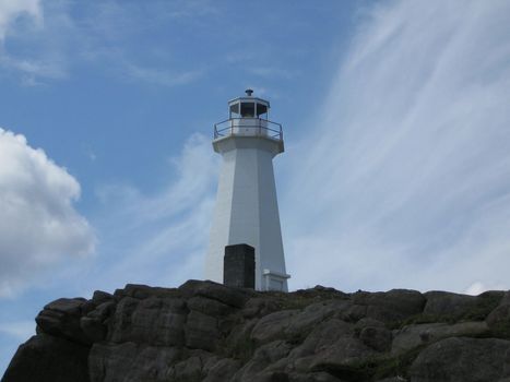 a light house sitting in the clouds in harbor grace, newfoundland, Canada
