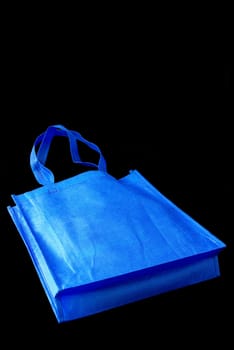 Blue bag on black background