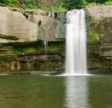 It is a beautiful waterfall over the river.