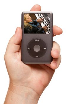 Man's Hand Holding Electronic Gadget with Female Singer on Screen Isolated on a White Background.