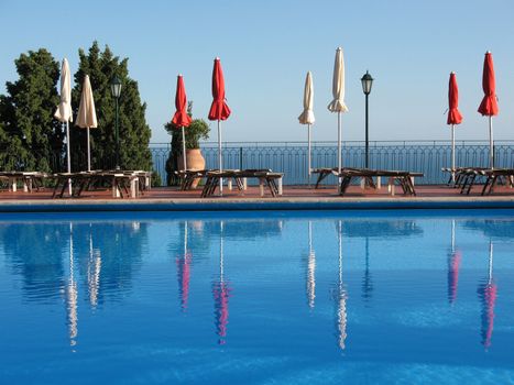 sunbeds and umbrellas by the pool 