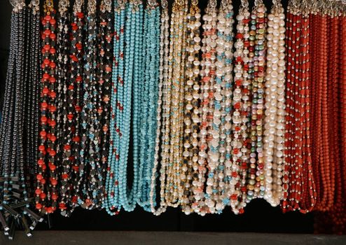 strings of colored bead necklaces in a row