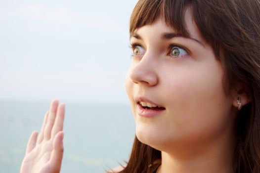 Women's sunset portrait on sea background