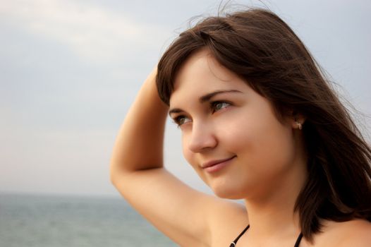 Women's sunset portrait on sea background