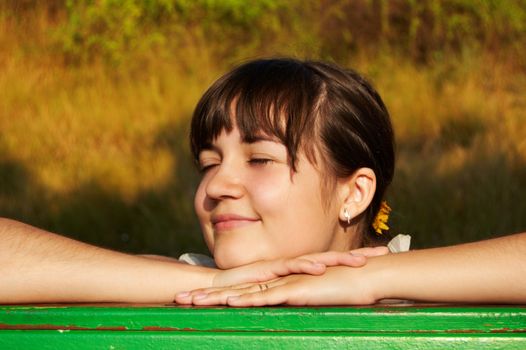 Women's sunset portrait on colored nature background