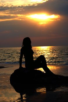 A woman early in the morning on the sea