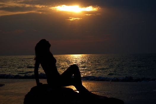 A woman early in the morning on the sea