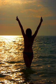 A woman early in the morning on the sea