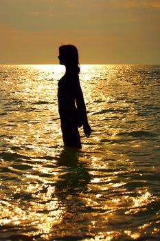 A woman early in the morning on the sea