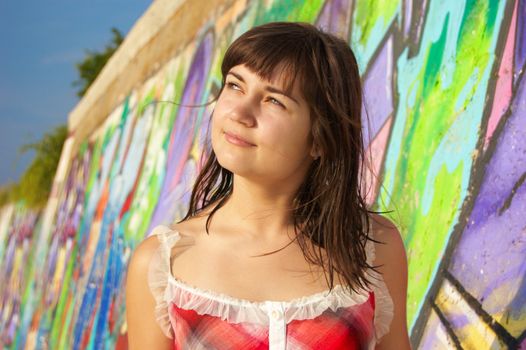 Women's  portrait on a colored wall background