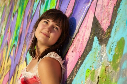 Women's  portrait on a colored wall background