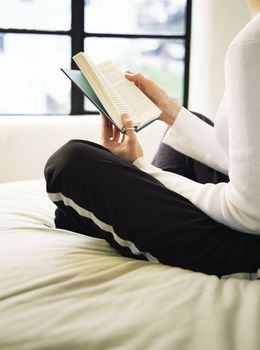 Reading a Book on Her Bed