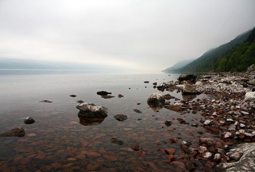 A view of Scotland's Loch Ness. Taken low on the shoreline to capture the reflection and foggy clouds in the distance.
