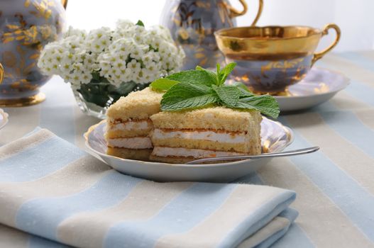 Sponge cake with a delicate souffle and a cup of tea