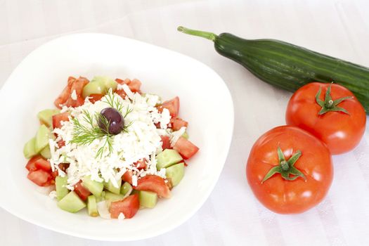 Fresh Mediterranean salad with tomatoes, cucumber, onion, feta cheese and olive.