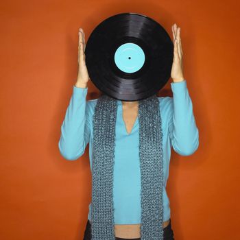 Portrait of Young Woman Holding Up Record in Front of Face