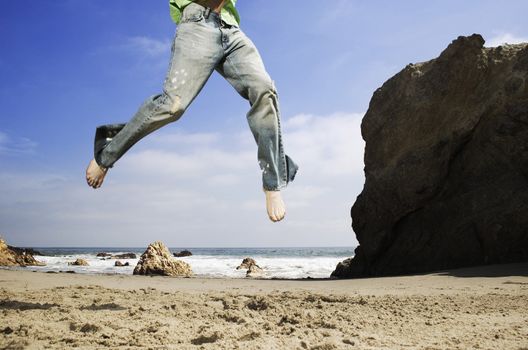 Legs of Man Jumping on Beach