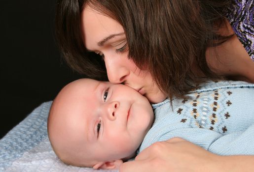 Mother kissing her baby boy