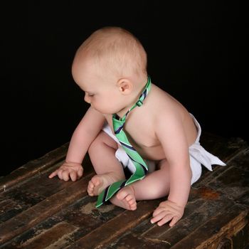 Cute caucasian baby wearing just a tie and diaper