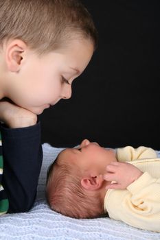 Blond boy with his newborn baby brother