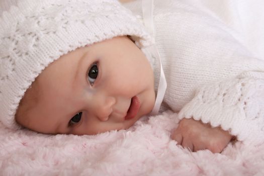 Beautiful two month old baby girl wearing a knitted outfit