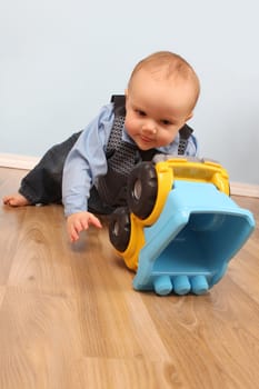 Baby boy playing with a toy truck