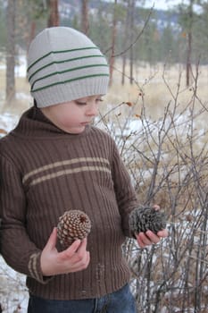 Warmly dressed boy outside in the snow 