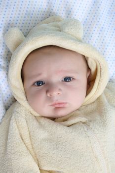 Two month old baby boy wearing a soft animal suit 