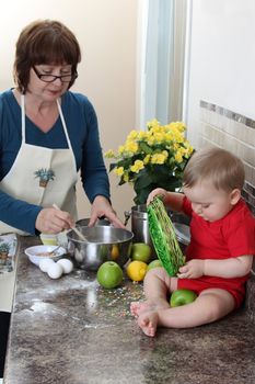 Grandmother and grandson in the kitchen baking cake