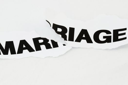 Word Marriage torn apart concept for divorce.