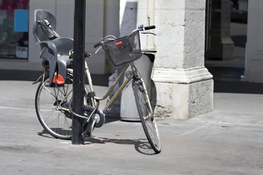 bicycle with child seat  locked on the  street  of Nice, France 