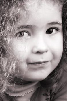 Beautiful young girl with curly hair and cute features
