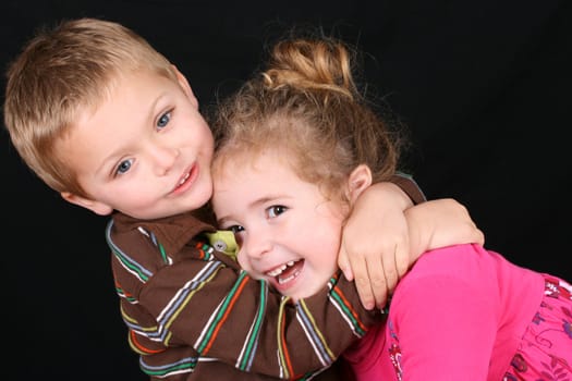 Beautiful young girl with curly hair and her cute boy friend
