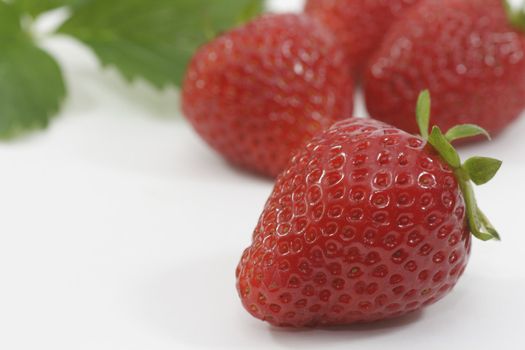 Close-up of fresh strawberries over white background