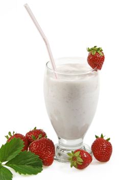 Milkshake with fresh strawberries over white background