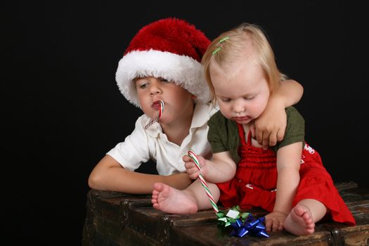 Christmas brother and sister eating Candy Canes 
