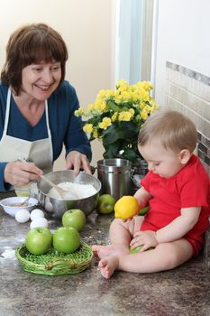 Grandmother and grandson in the kitchen baking cake 