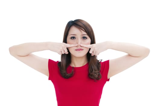 Portrait of an attractive young woman pressing against nose with her fingers, isolated on white background.