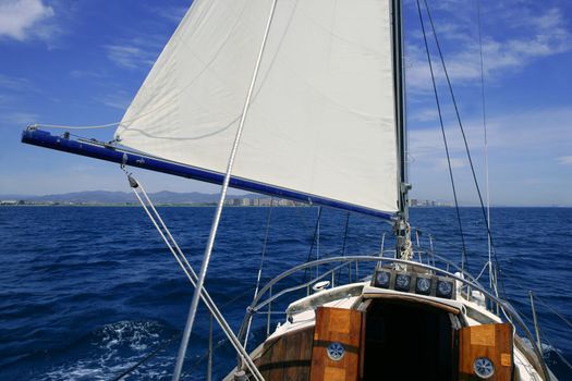 Sailboat sailing blue sea on sunny summer day in Mediterranean