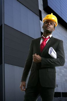 African american architect engineer with yellow hardhat and plans
