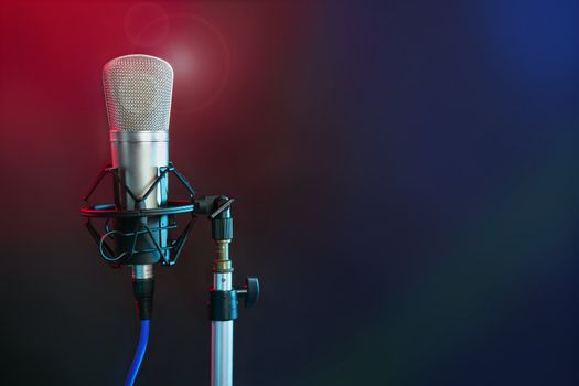 Microphone in the night colorful light in a recording studio