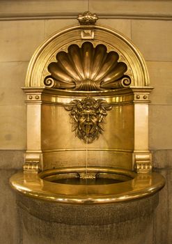 Gold baptismal font that works as a small fountain as well