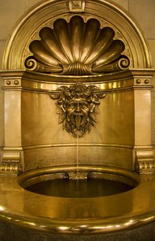 Gold baptismal font that works as a small fountain as well