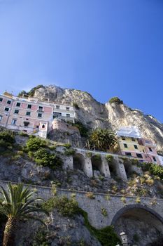 Houses on the cliff with flowers at the Amalfi coast in Italy