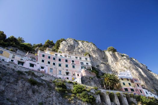 Houses on the cliff with flowers at the Amalfi coast in Italy